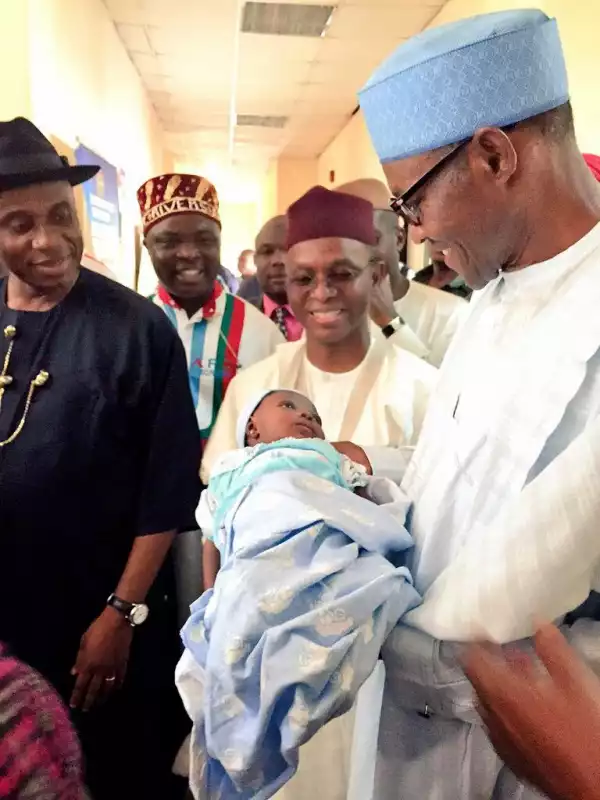 Baby gets a cuddle from Gen. Buhari at Rivers Heath centre