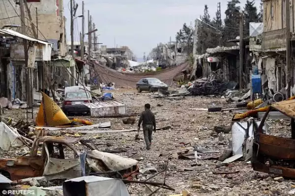 Executed ISIS fighters lined up in the ruins of border town of Kobane