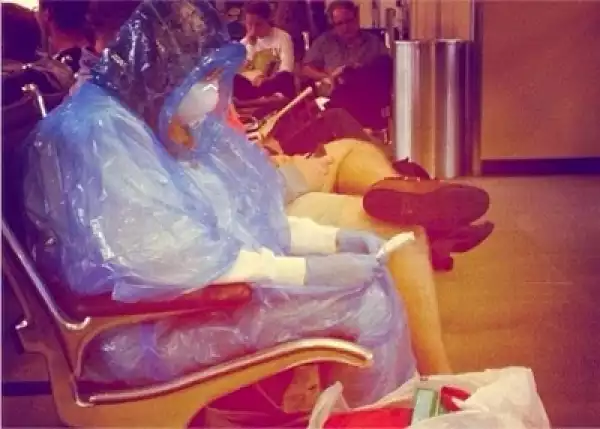 POTD: woman arrive airport suited in Ebola kit