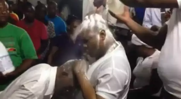 Pastor washes the sins of his congregation with soap and bleach