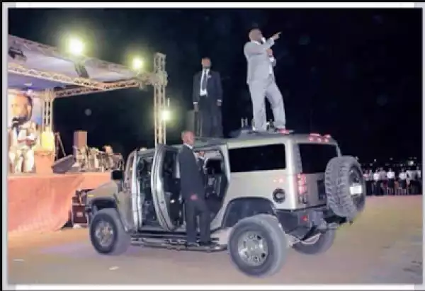 Photo: Pastor & His Bodyguard Climb On Top Of His Jeep To Preach To Congregation