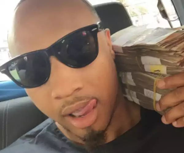 Singer B-Red poses with wads of Naira notes