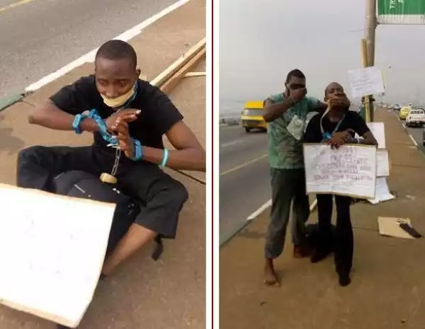 Two Young Men In Chains On 3rd Mainland Bridge To Mark Missing Chibok Girls 1 Year Anniversary