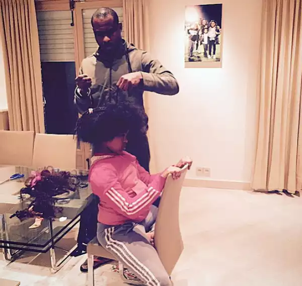 Vincent Enyeama pictured grooming his daughter