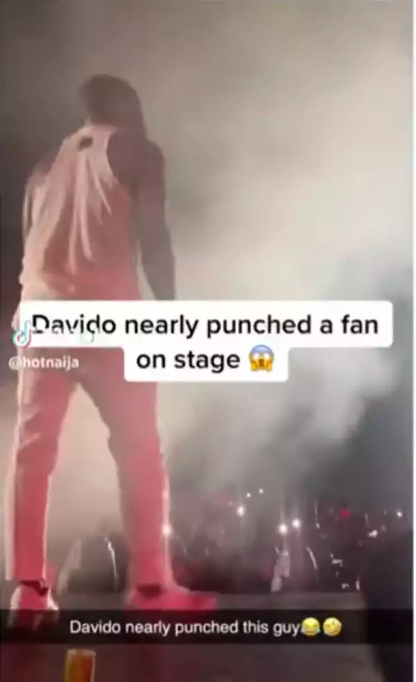Davido nearly punches a fan who jumped on the stage and started pointing at him at his Timeless Concert in Lagos