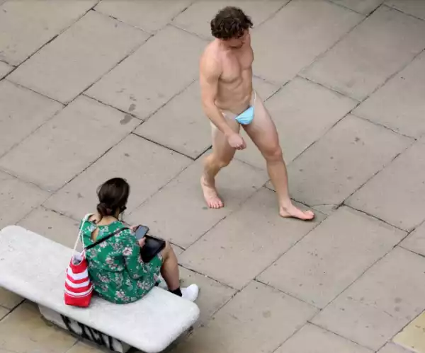 Naked man strolls down Oxford Street wearing nothing but mask