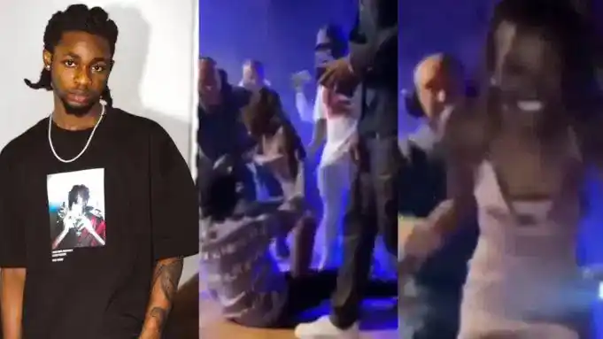 Overzealous fan smiles triumphantly as she’s led off stage after she mounted Omah Lay during his performance in Sweden (Video)