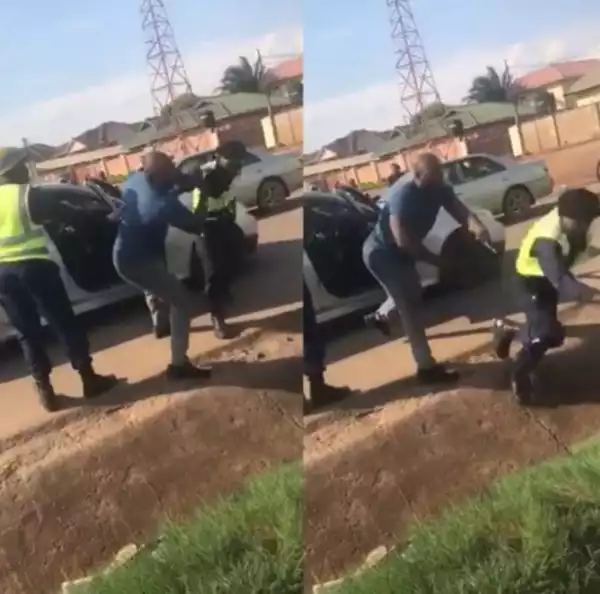 Drama As Man Fights Officers And Flings One Into Gutter After They Stopped Him And Tried To Force Him Out Of His Car (Video)