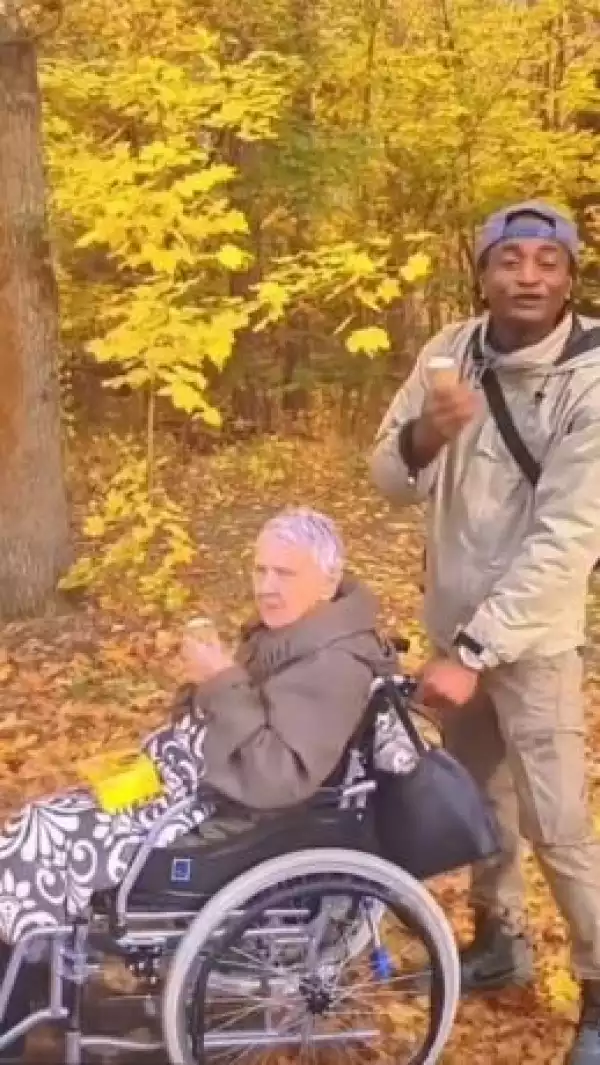 Young Nigerian Man Shows Off His Old German Sugar Mummy In Wheelchair (Photo/Video)
