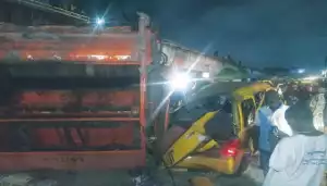 Commotion As Refuse Truck Falls Off Lagos Bridge, Kills Tricycle Rider