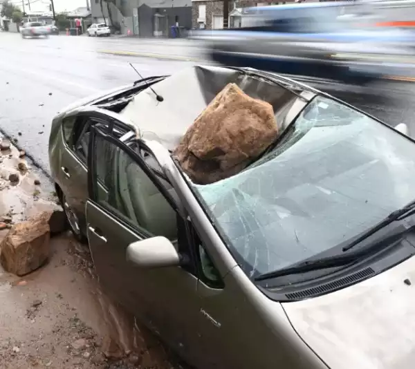 Man Escapes Death After Huge Rock Crushes His Car After He Stepped Out To Take A Phone Call