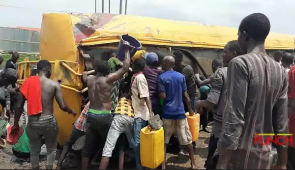 Drama As Youths Storm Tanker Accident Scene To Scoop Fuel In Lagos Despite Lockdown (Photo)