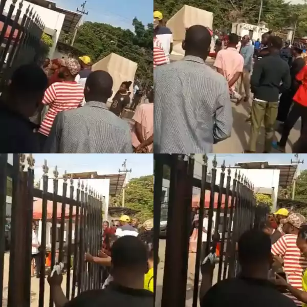 Angry Abuja residents forcefully unlock gate of a bank as Naira scarcity persists