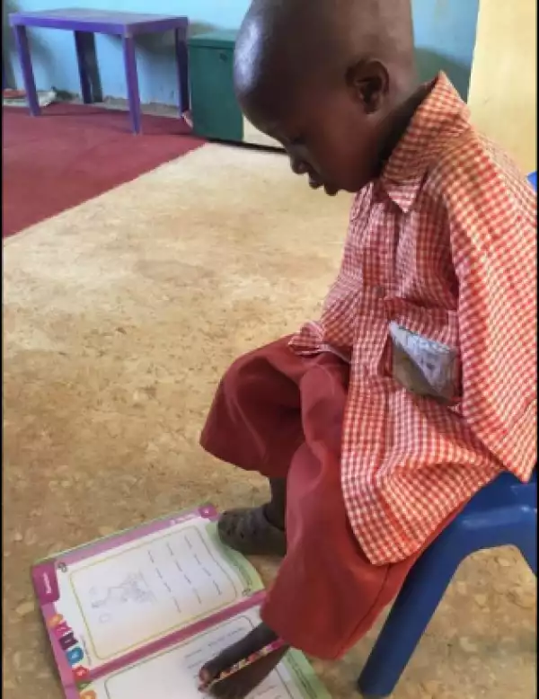 Meet 4-year old armless Nigerian schoolboy who writes with his toes