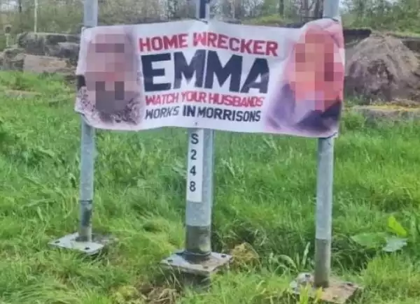 Banner Calling Out "Home Wrecker" With Her Face And Work Place On Display Is Spotted On The Roadside
